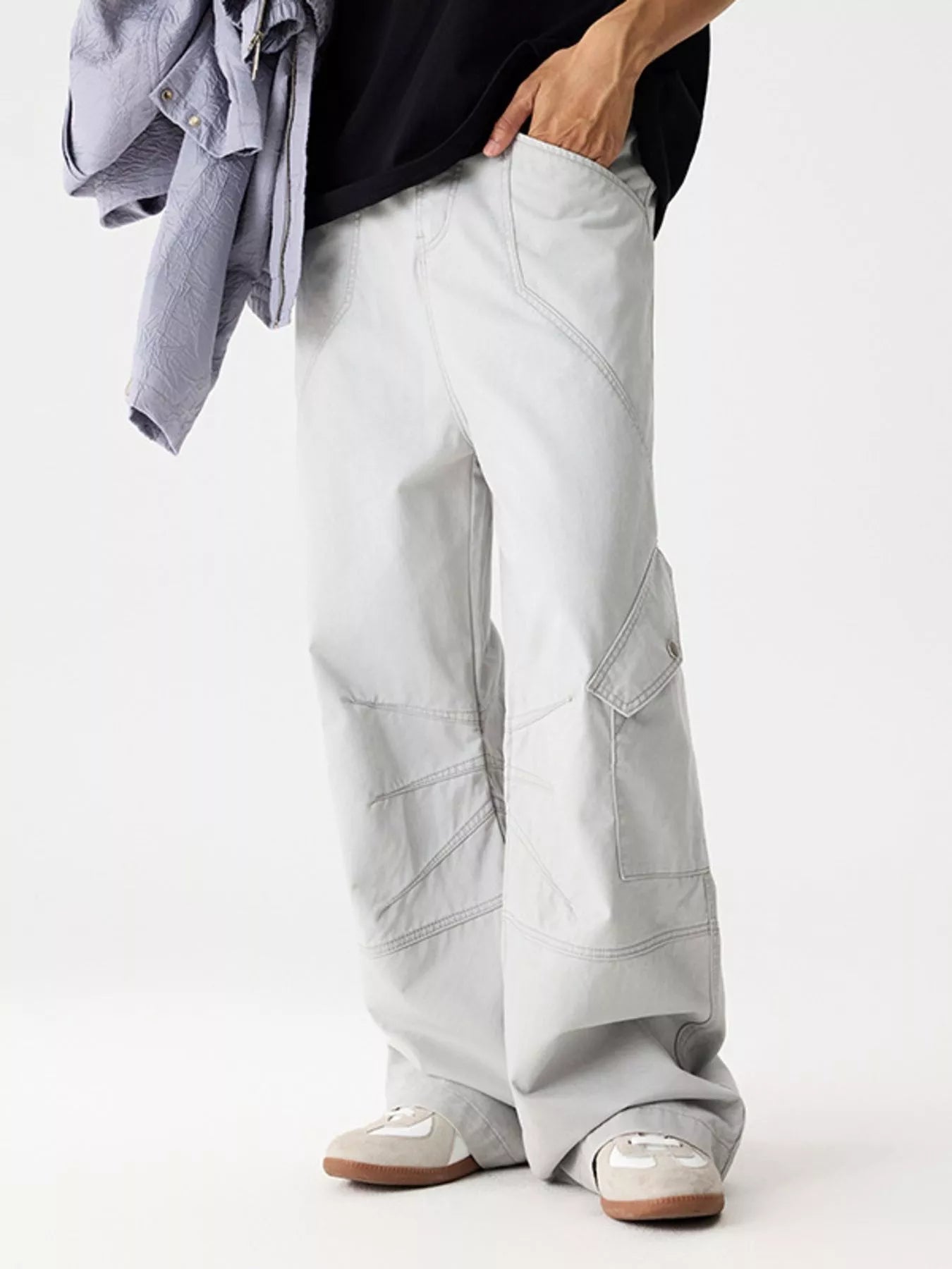 Men's light gray wide leg cargo pants with pockets.
