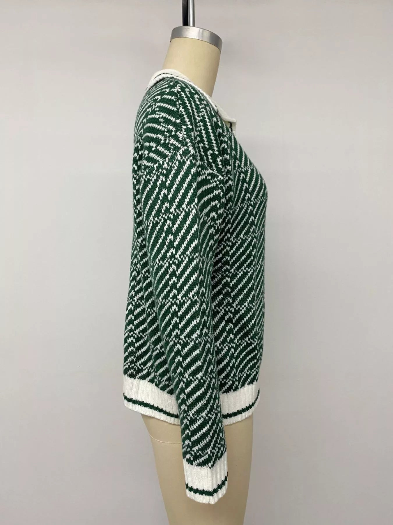 Side view of the green and white geometric collared sweater on a mannequin