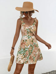 Women's khaki printed mini dress with ruffles, a surplice neckline and wide straps.