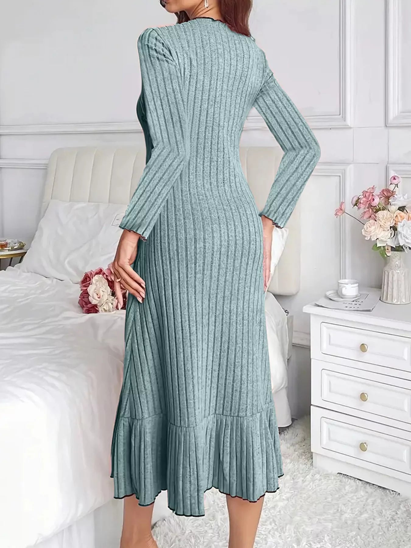 Back view of turquoise ribbed knit bodycon dress with ruffle hem indoors