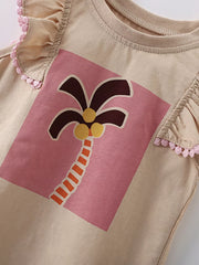 Angled close-up of the palm tree graphic on a pink panel with ruffle trim visible
