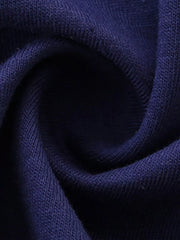 Close up of gathered dark navy fabric showing the plain knit texture of a children's tee