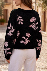 Back view of black floral pullover sweater with pink flowers and dropped shoulders