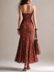 Back view of rust floral spaghetti strap maxi dress with open back and flared hem