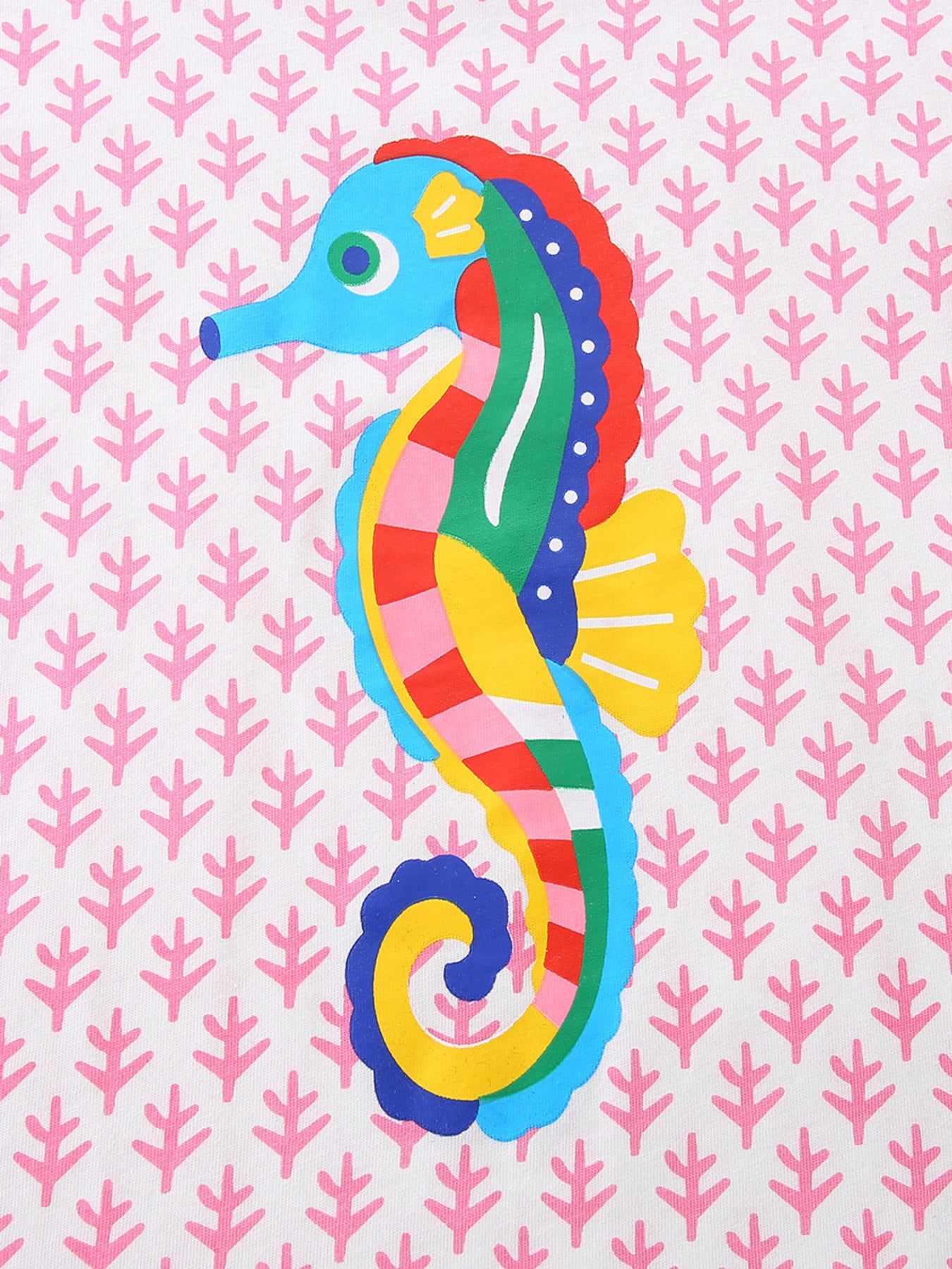 Close-up of the striped multicolor seahorse print on the blush pink children's tee