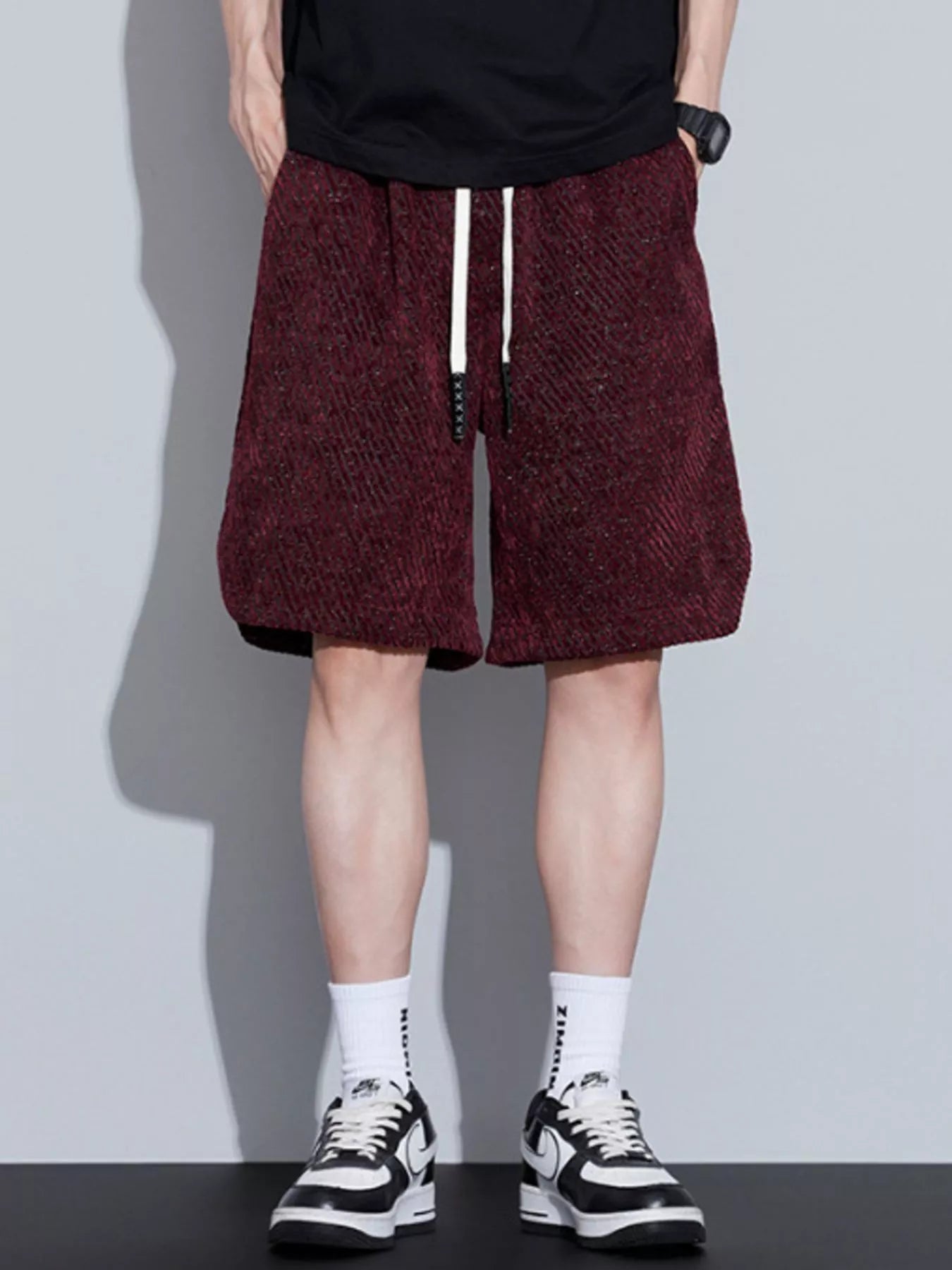 Men's loose fit shorts with a drawstring waist and pockets.