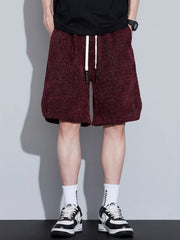 Men's loose fit shorts with a drawstring waist and pockets.
