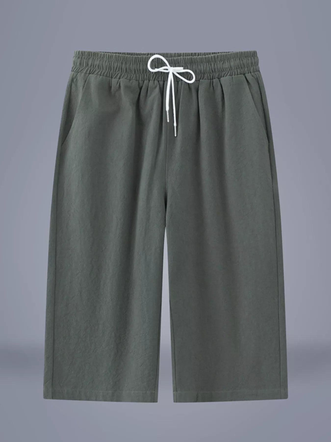 Men's army green cropped casual pants with a drawstring waist and pockets.