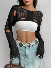 Front view of black distressed cropped knit cover up with openwork and cutouts.