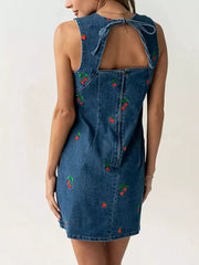 Back view of blue sleeveless denim dress with back zip and strawberry embroidery