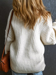 Back view of white slouchy chunky ribbed knit sweater with long sleeves and ribbed hem.