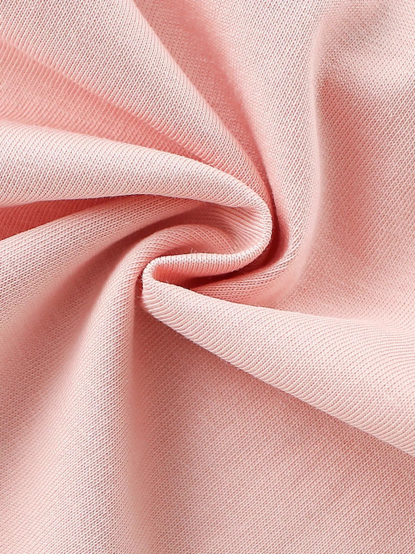 Close up of soft blush pink fabric texture of children's ruffle sleeve t-shirt