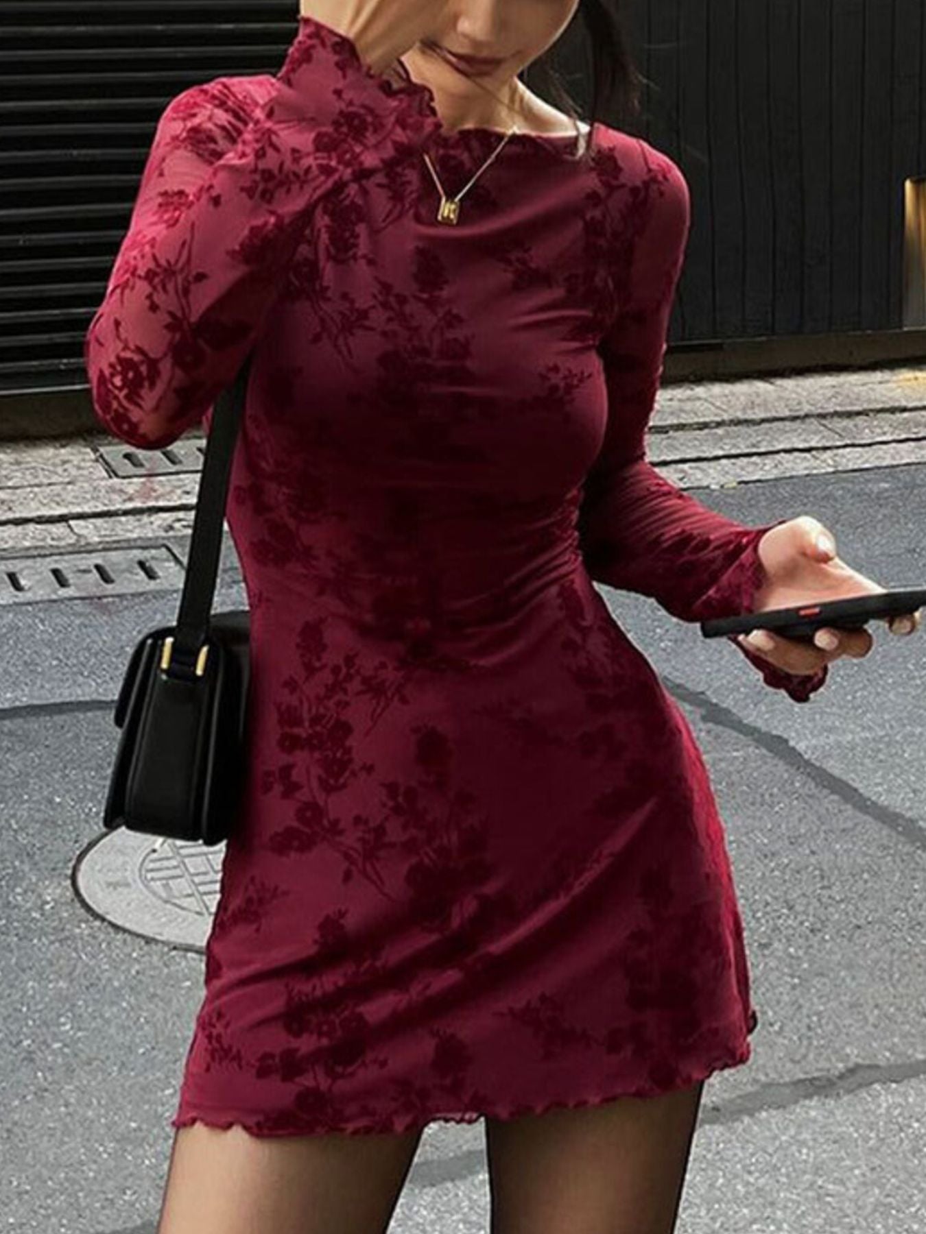 Burgundy floral long sleeve bodycon mini dress with sheer sleeves, front view outdoors
