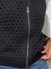 Close up of the black crochet cardigan lower zip and ribbed hem