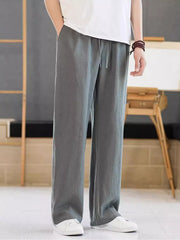 Men's dark gray casual pants with a drawstring waist and pockets.