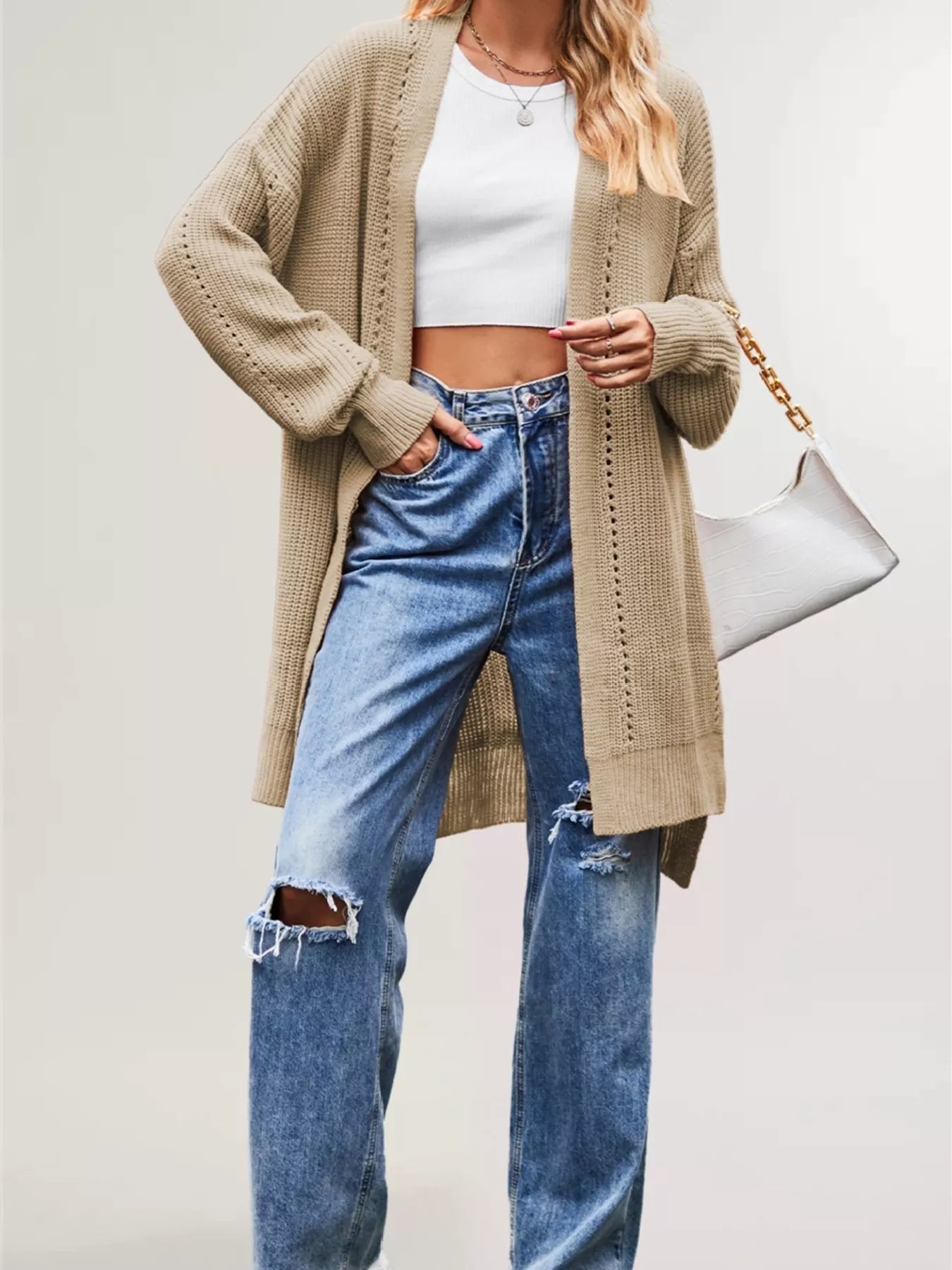 Khaki long open front cardigan with openwork stripes worn over jeans
