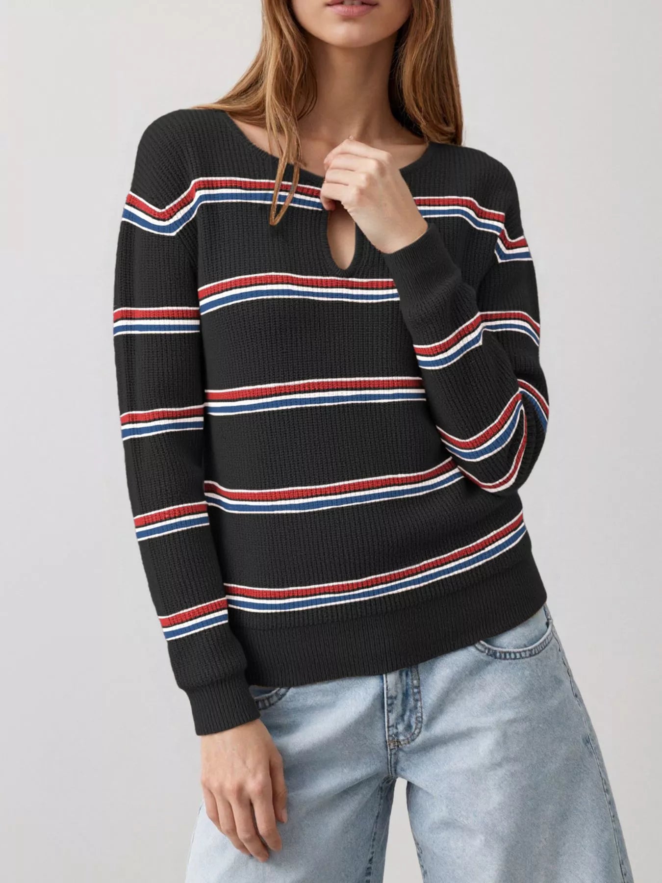 Front view of a black striped ribbed knit top with a keyhole neckline