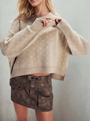 Close front view of the khaki dotted sweater showing long sleeves and ribbed cuffs