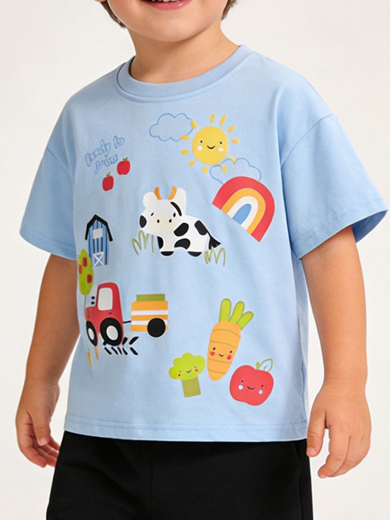 Front view of light blue children's T-shirt with a cartoon cow, tractor, rainbow and barn print