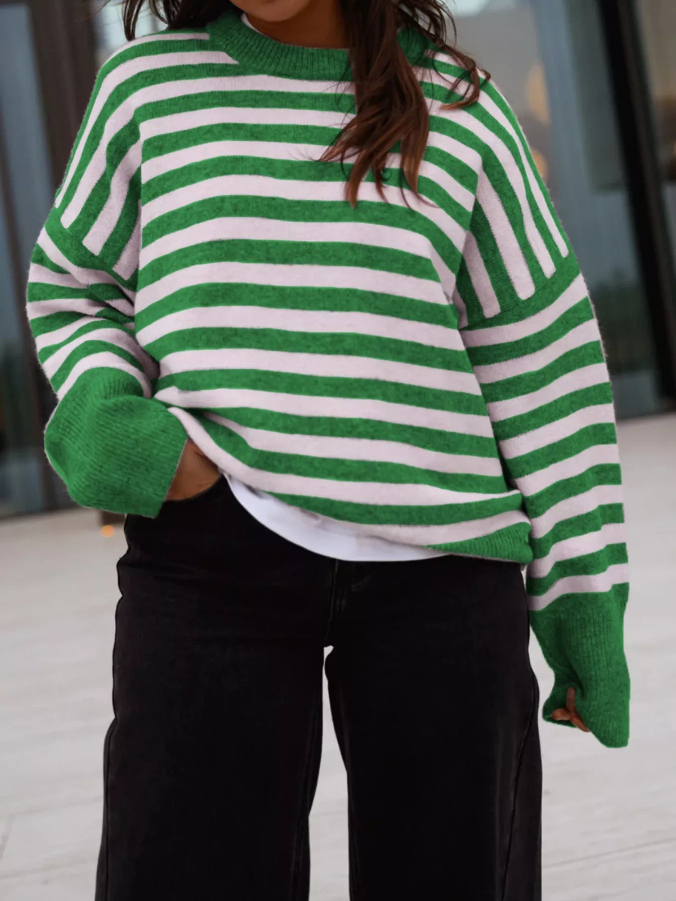 On-model front view of a green and white striped crew neck sweater