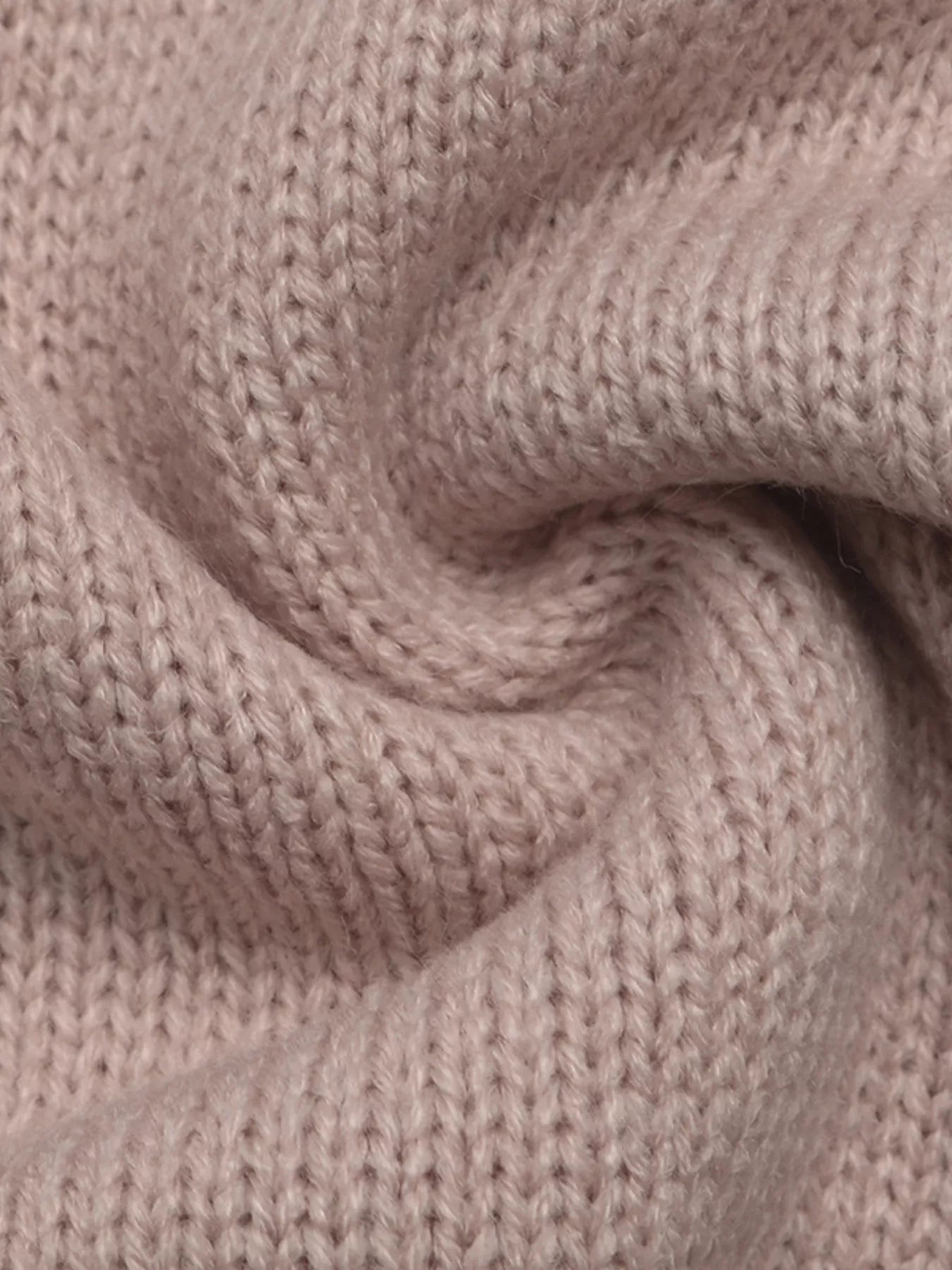 Close up of soft pink knit fabric showing its fine ribbed texture