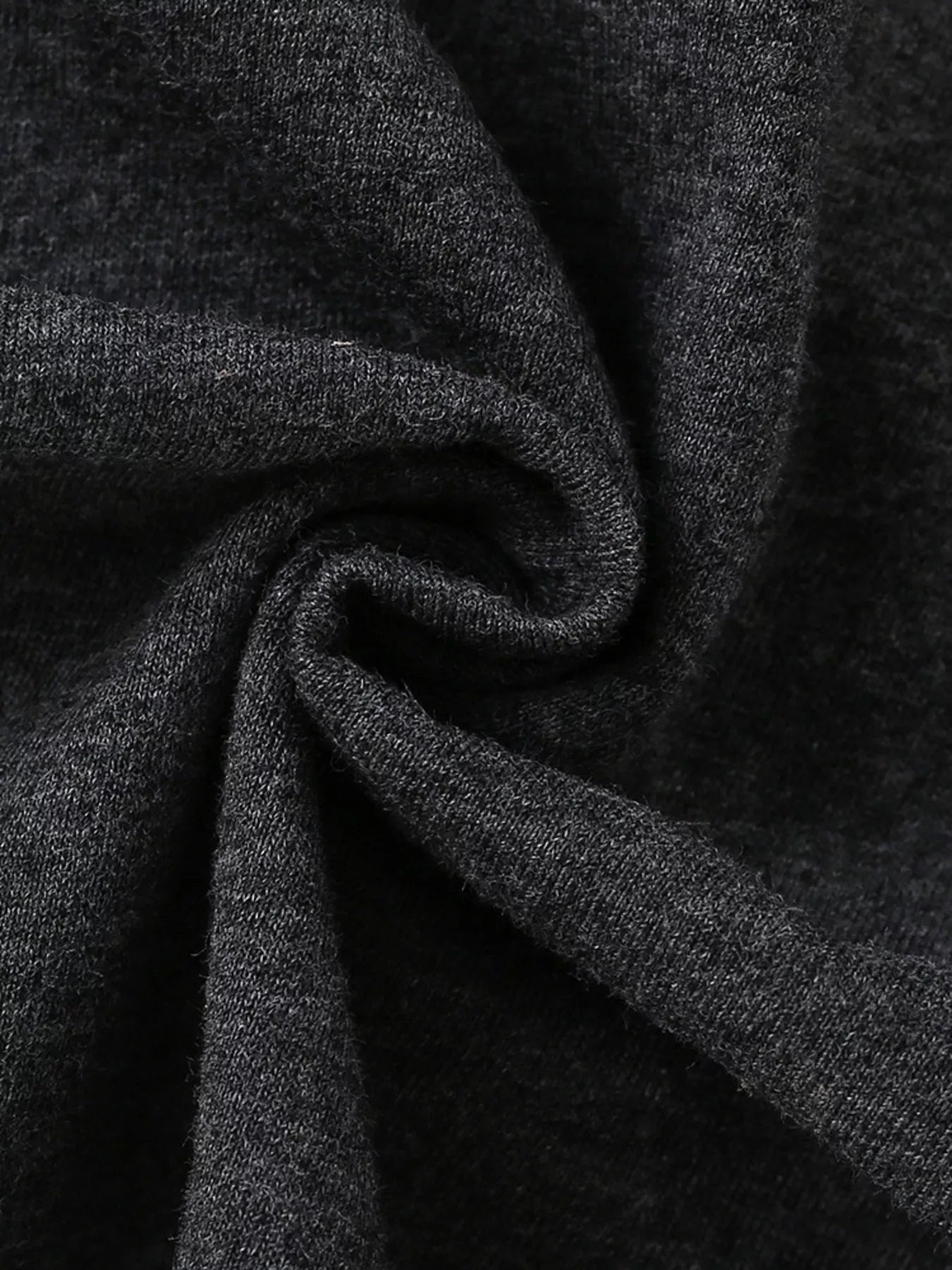 Close up of soft dark gray heathered fabric texture of children's short sleeve t-shirt