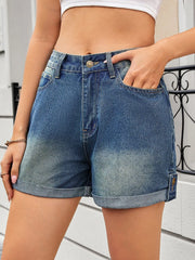 Women's high-waisted gradient denim shorts with rolled hems, buttons, and pockets.