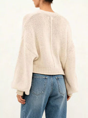 Back view of a cream oversized chunky knit sweater with balloon sleeves