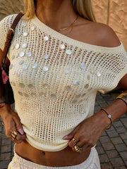 Close up of a cream open knit top with pearl sequins and an off shoulder neckline