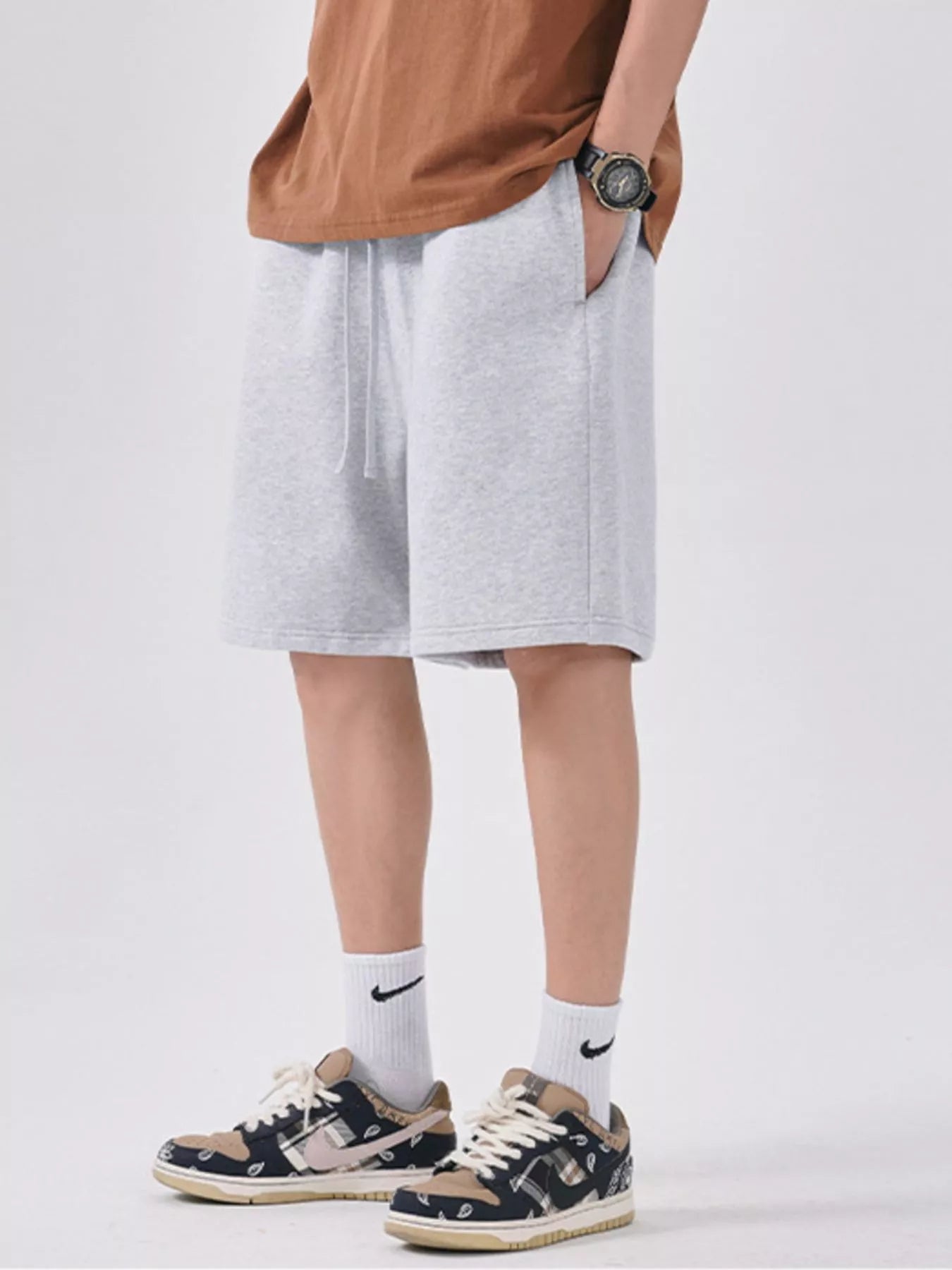 Men's light gray casual shorts with a drawstring waist.