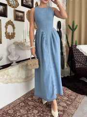 Light blue sleeveless denim midi dress with fitted bodice and flared skirt, angled front view indoors