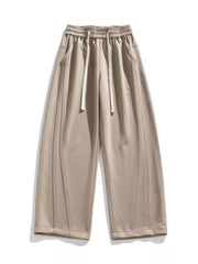 Men's khaki loose-fit wide-leg pants with a drawstring waist and pockets.
