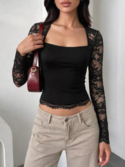 Black square-neck top with sheer floral lace long sleeves and scalloped lace hem, styled with beige pants.