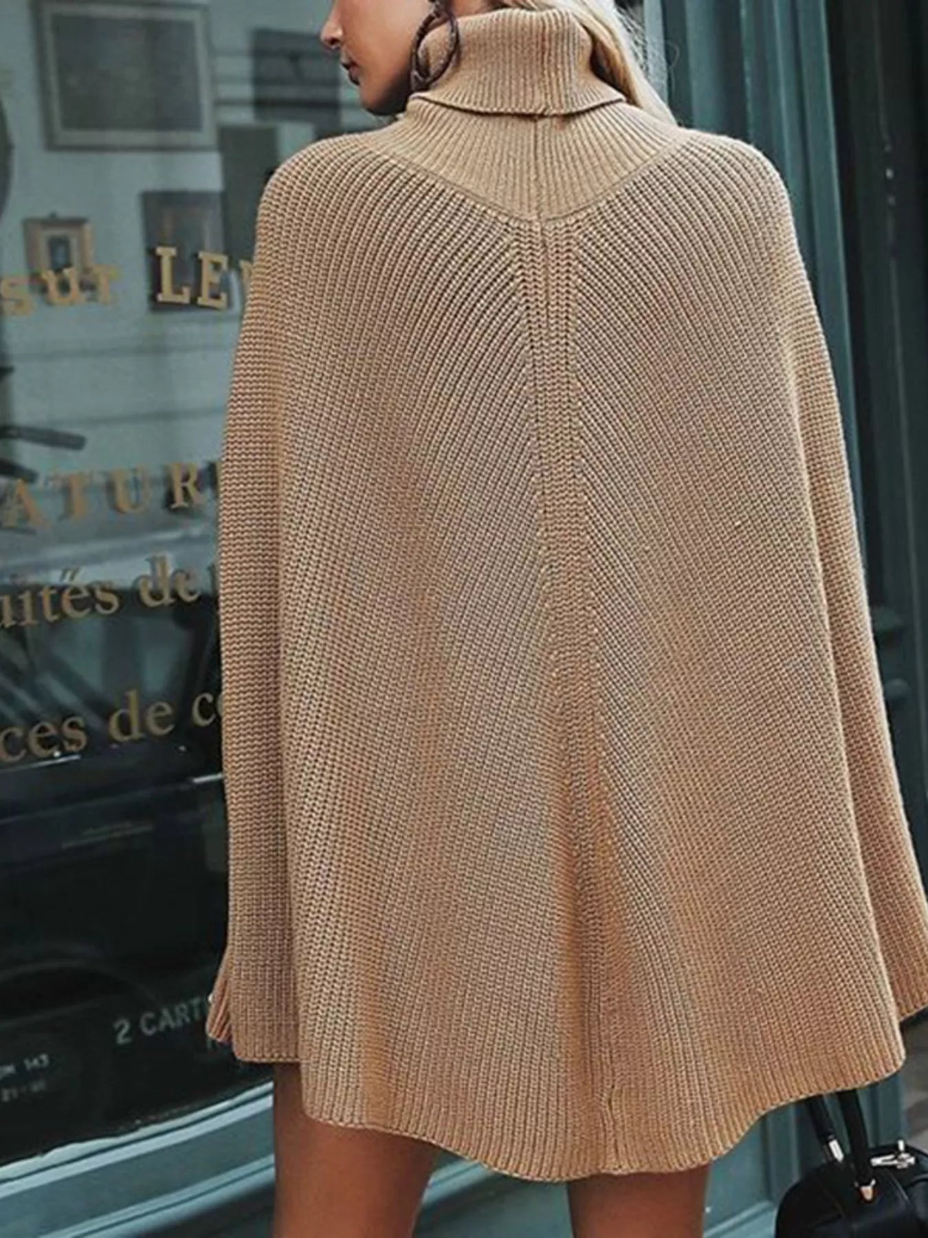 Back view of camel ribbed turtleneck poncho sweater