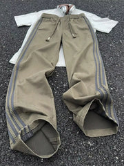 Men's striped wide leg pants with a drawstring waist and pockets.