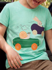 Green children's short sleeve T-shirt shown worn with a snail and bunny racing in vegetable cars