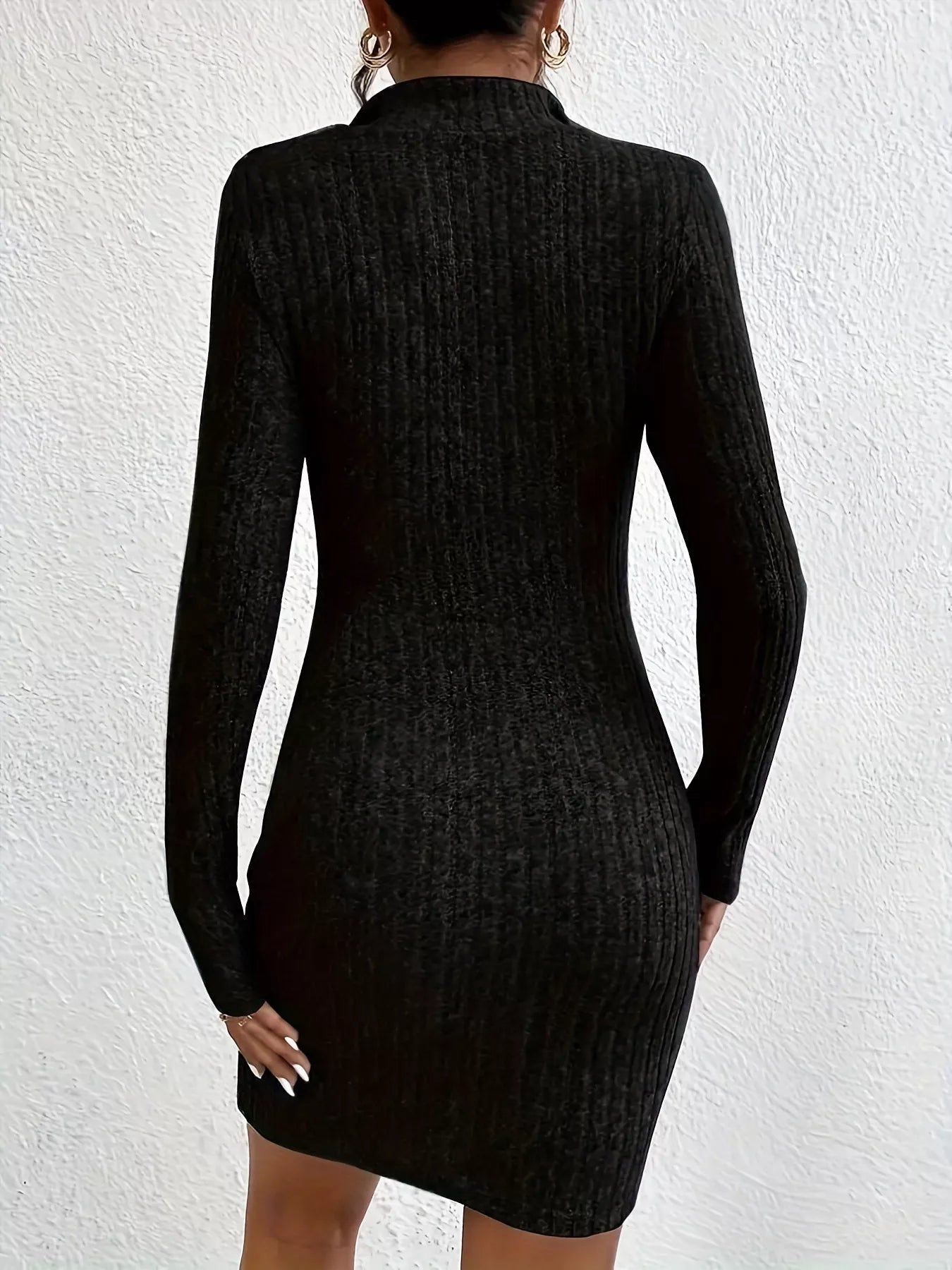 Back view of black ribbed knit bodycon mini dress with long sleeves