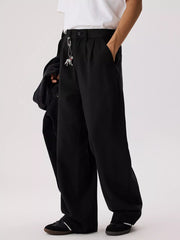 Men's relaxed fit pants with a drawstring waist and pockets.