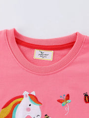 Close view of the ribbed crew neckline and unicorn head on a pink children's sweatshirt