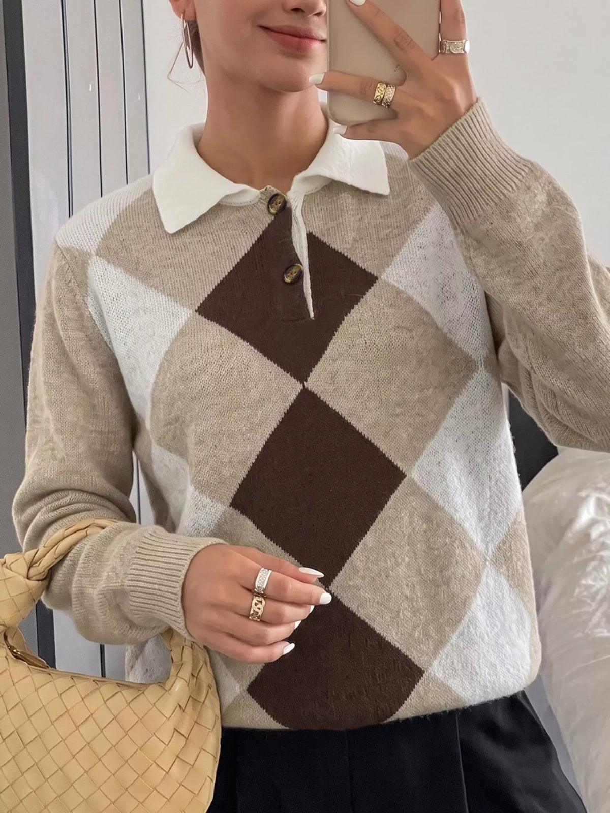 Mirror selfie front view of a beige, brown, and white argyle polo collar sweater