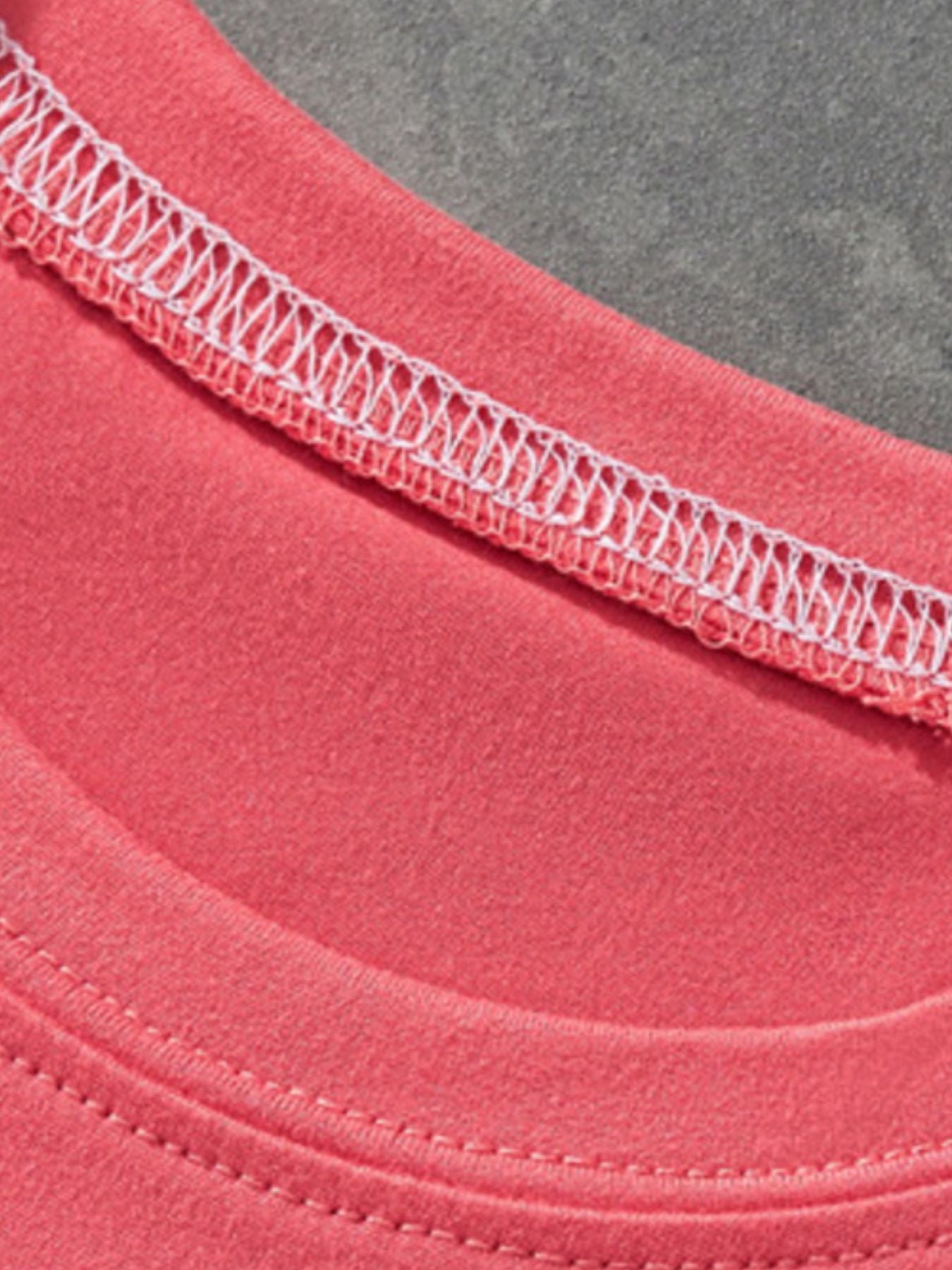 Close-up of coral children's t-shirt neckline showing white stitching and soft fabric texture