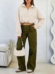 Full length front view of apricot half zip sweatshirt styled with olive cargo trousers