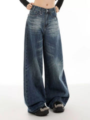 Women's vintage blue wide-leg jeans with washed detailing and pockets.
