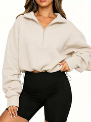 Front angled view of apricot half zip sweatshirt with drawstring hem and long sleeves