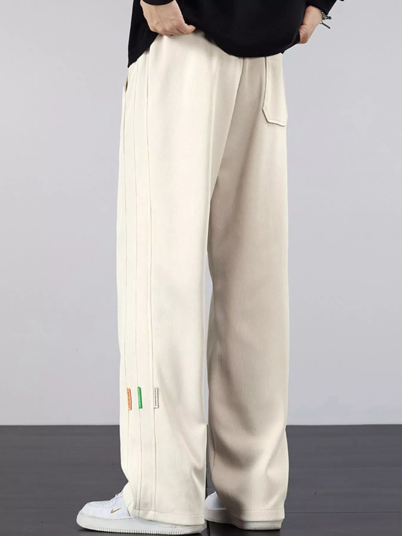 Men's casual loose fit pants with a drawstring waist and pockets.