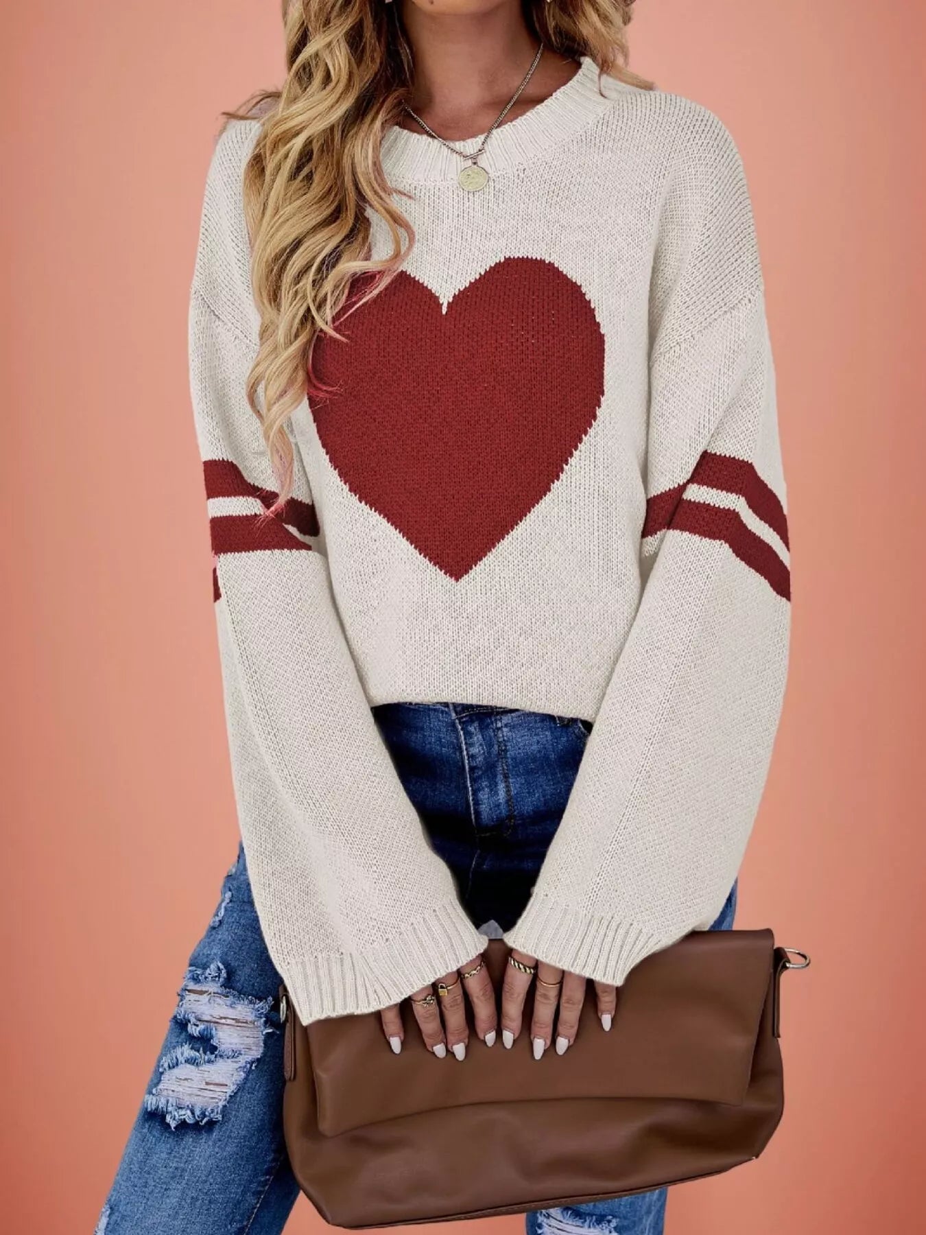 Front view of a cream dropped shoulder sweater with a large red heart