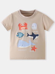 Tan children's short sleeve tee with colorful ocean animal graphics, laid flat in front view