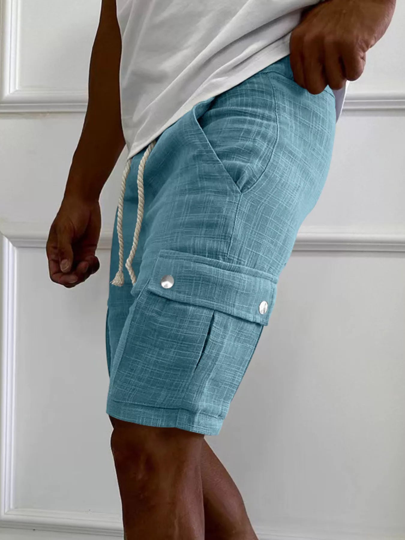 Men's light blue cargo shorts with a drawstring waist and pockets.