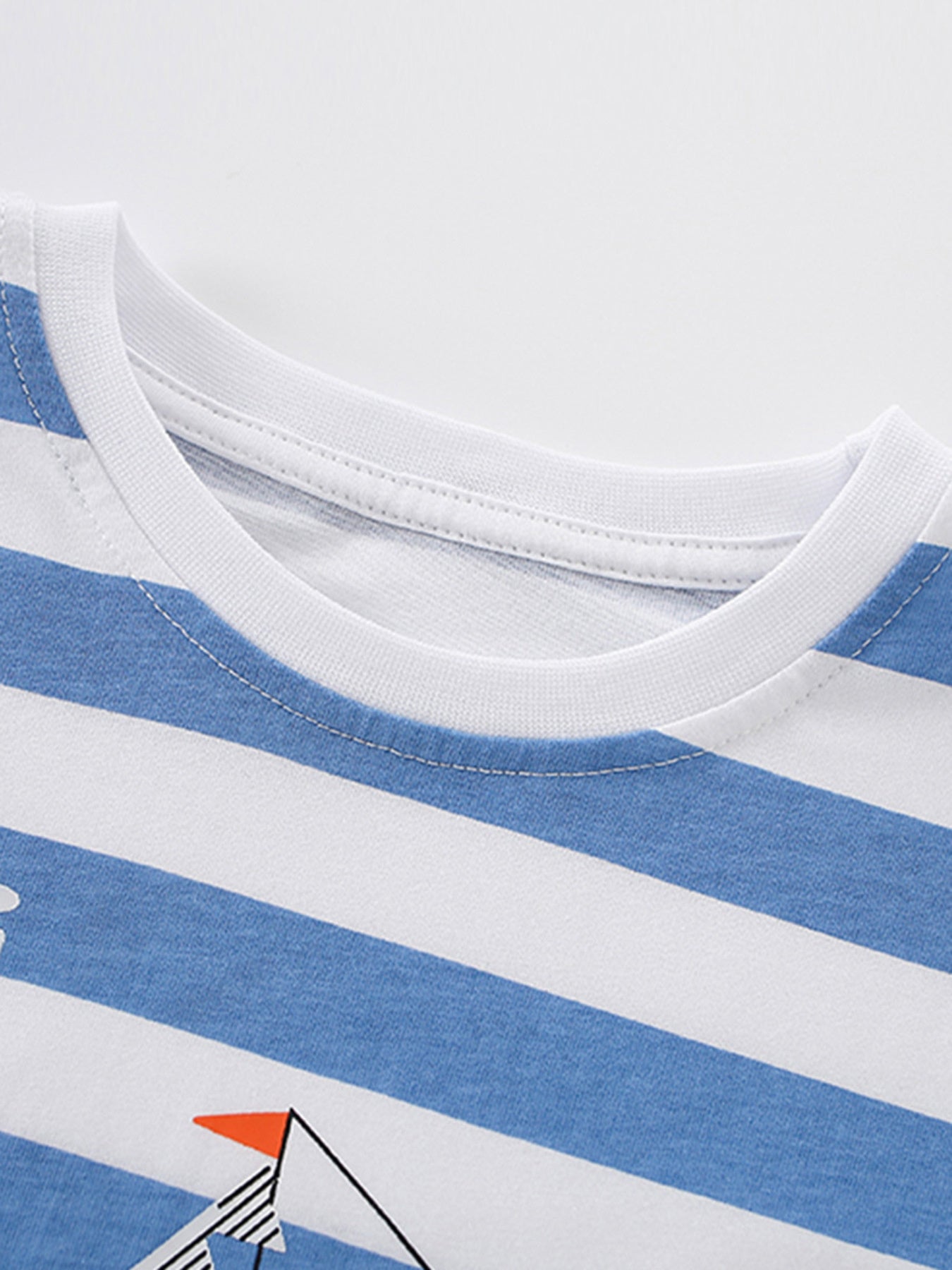 Close-up of the white ribbed round neckline on a blue and white striped children's printed T-shirt
