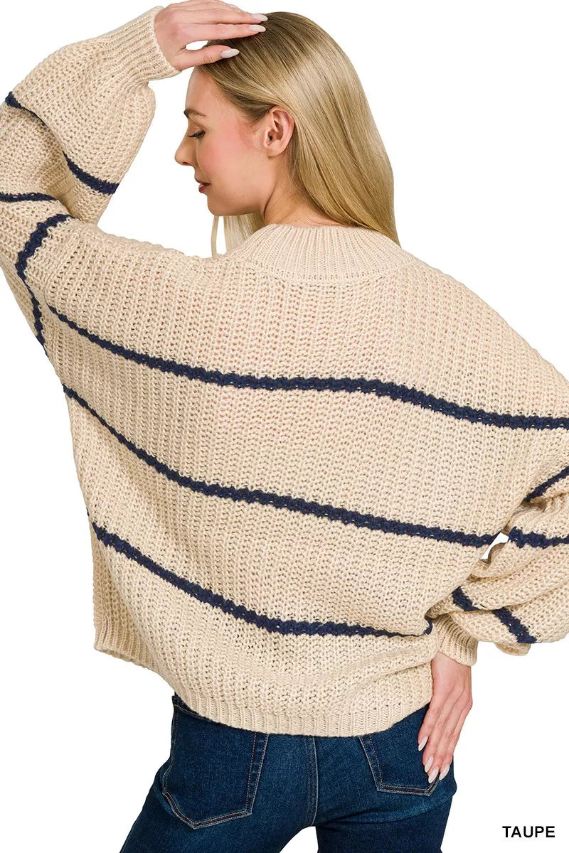 Back view of cream oversize striped sweater with navy horizontal stripes and jeans